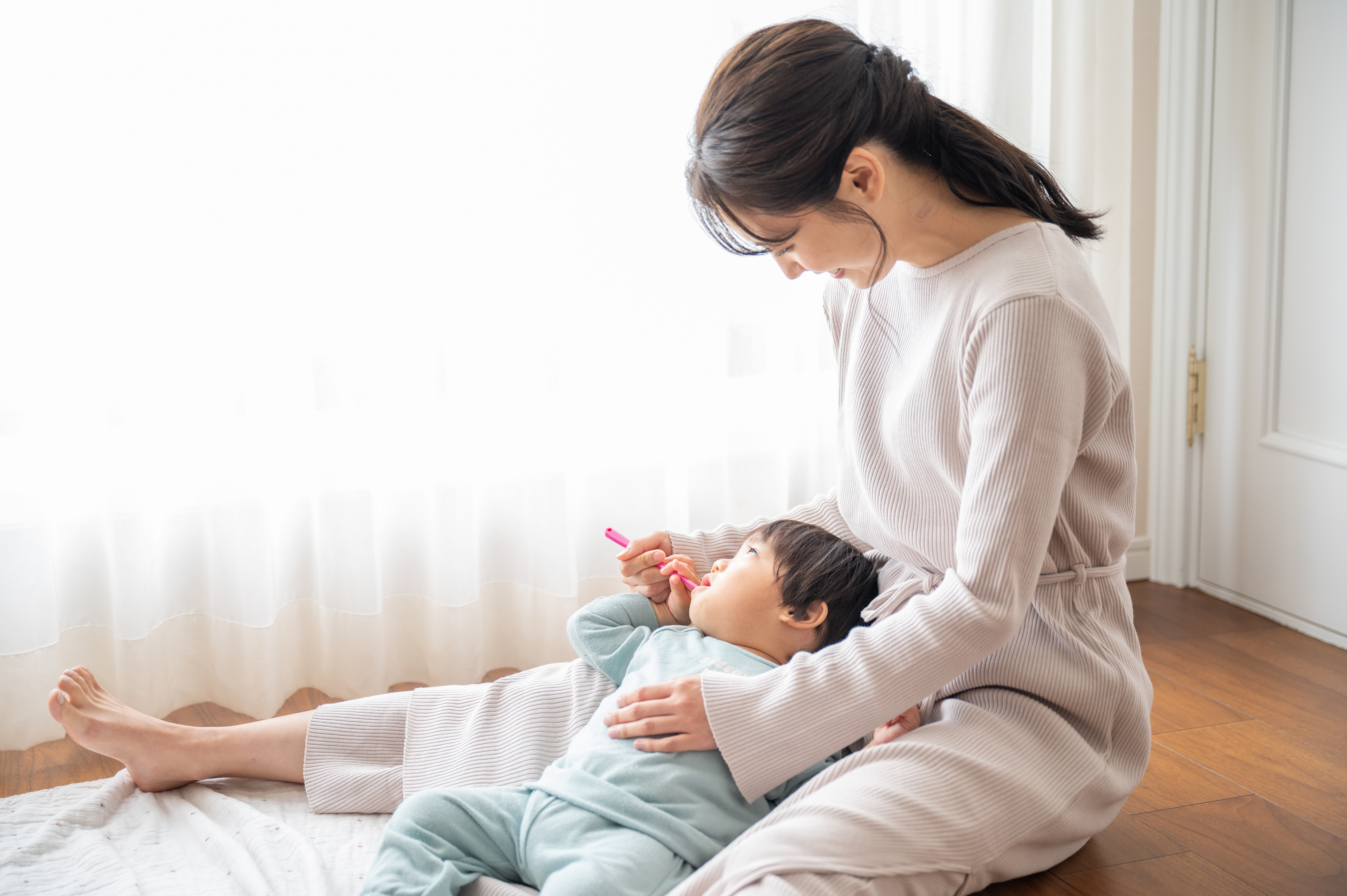 仕上げ磨きをする母親